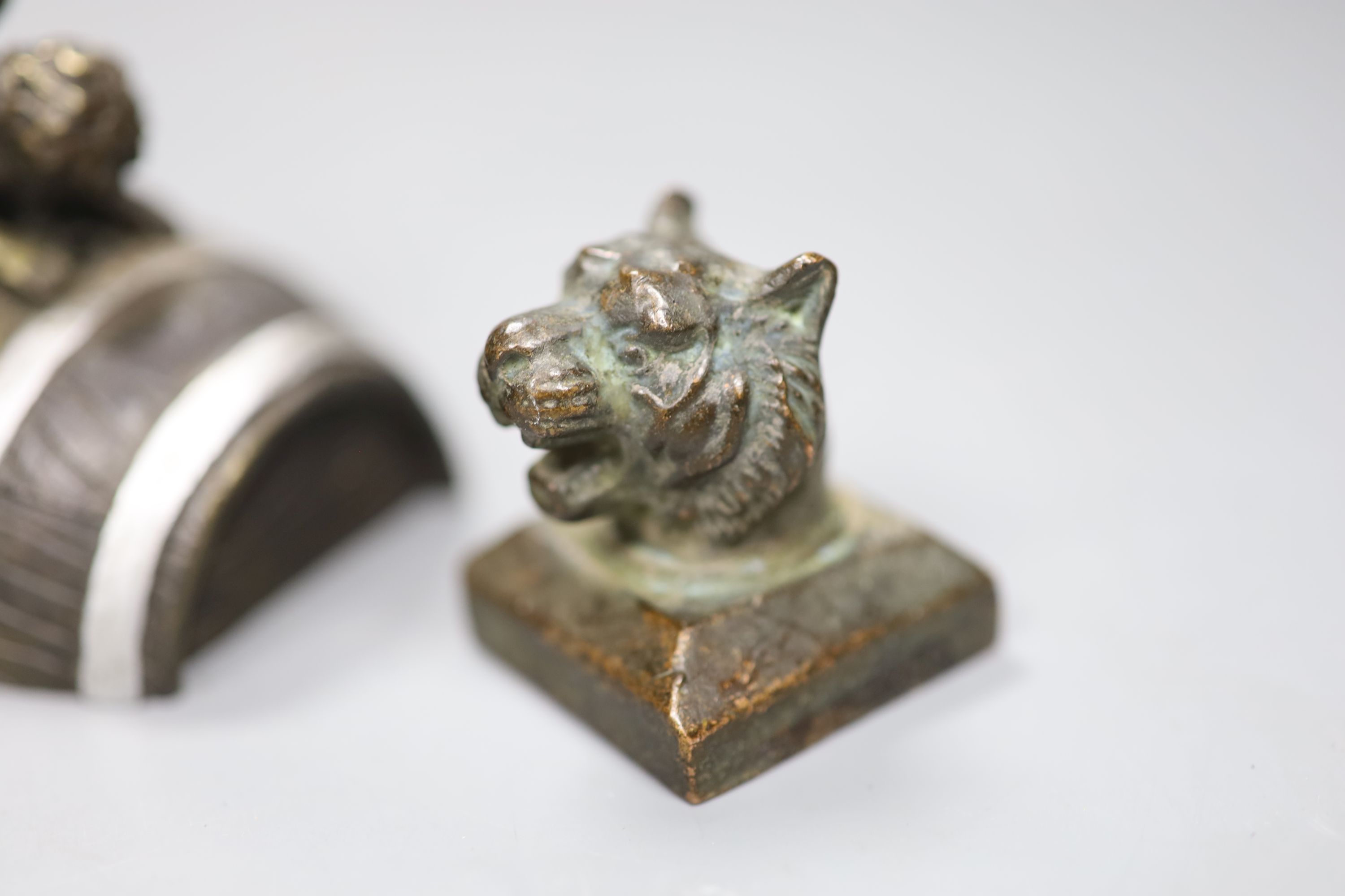 Two novelty bronze seals and novelty bronze cherub group, height 9cm